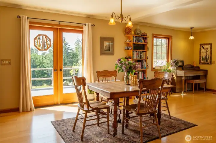 Main house floor 1 dining area and doors to west-facing deck