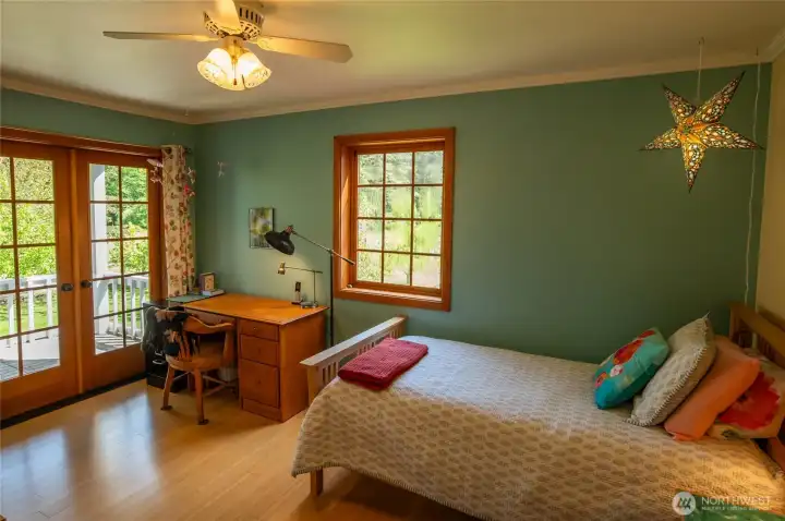 Main house floor 2 second bedroom with walk-in closet, private deck overlooking the garden