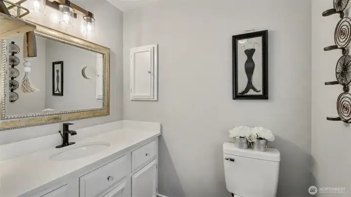 Spacious primary bath offers newer vanity with quartz counters