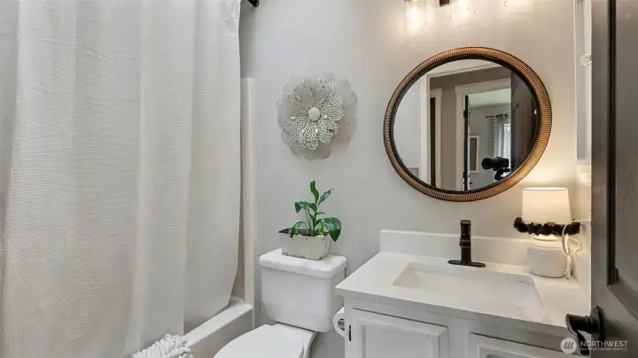 Guest bath offers newer vanity with quartz counters