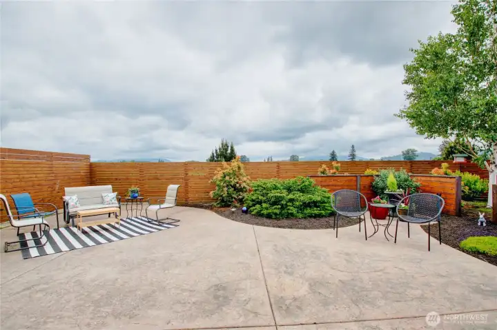 Fenced backyard with pavers and colorful landscaping. Fenced backyard with pavers and colorful landscaping.