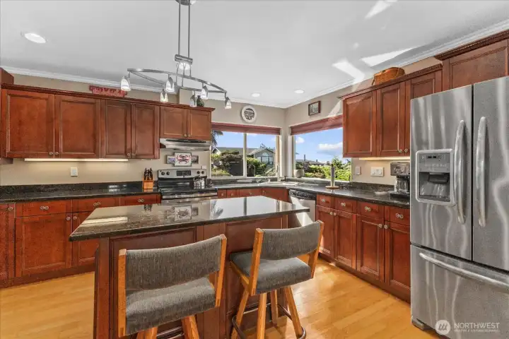 Work island in kitchen with space to enjoy morning coffee. Work island in kitchen with space to enjoy morning coffee.