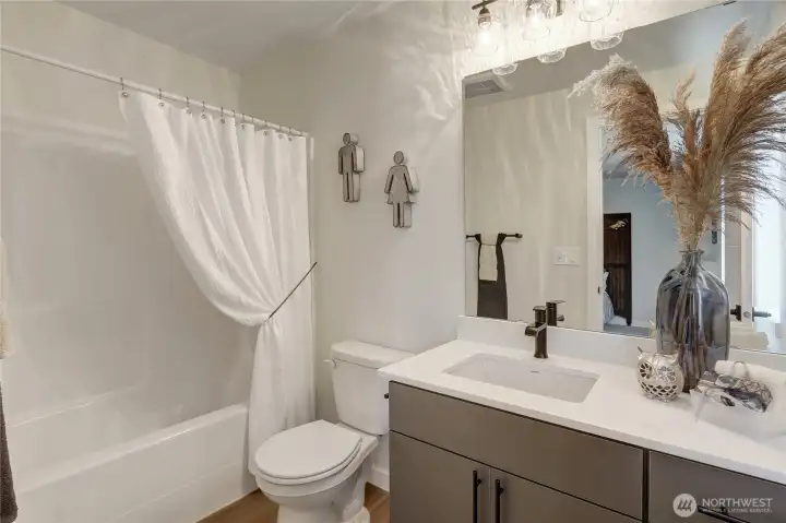 Full bath attached to the 2nd upper level bedroom.