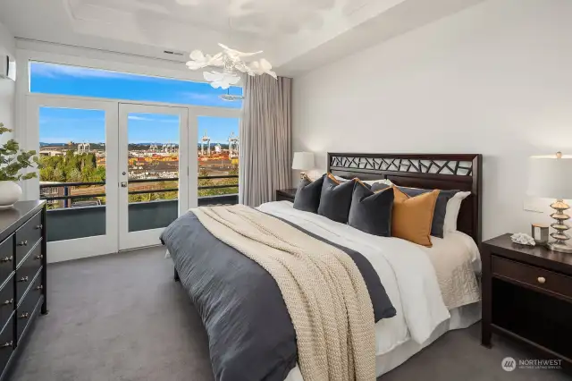 Primary bedroom features high ceilings, designer lighting and expansive balcony with amazing views!