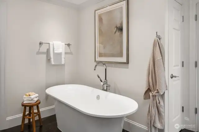 Lower-level full primary bath with stand-alone tub.