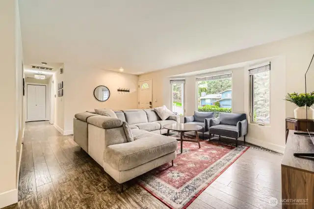 The formal living room features a bay window for added natural light.
