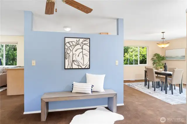 The flex space to the right of the kitchen is currently staged as a dining area, but could be used for many different purposes. There is a sliding patio door that leads to the back yard just to the right of this photo.
