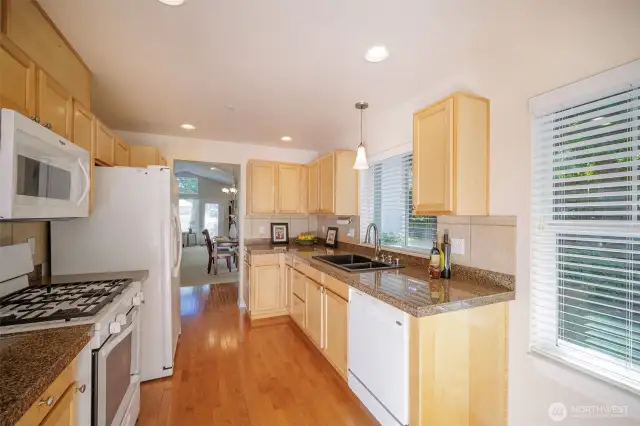 Well designed kitchen with gleaming hardwoods.