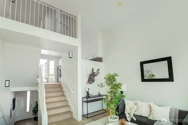 Living Room with Stairs up to Kitchen and Down to Entry