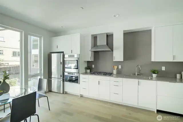 Kitchen with deluxe appliance package with features including Energy Star efficiency, Wifi connection, cabinet panel dishwasher with low sound operation and/or Power Clean steam clothes washer