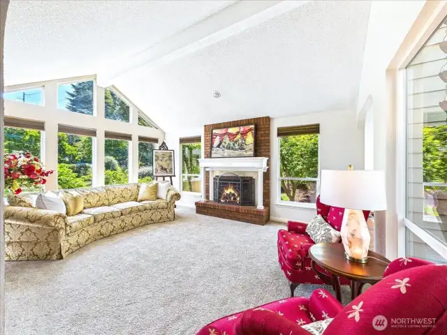 Large front living room looks out to the mature front yard and the solarium/atrium.