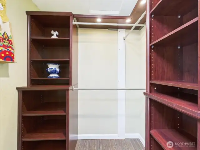Primary walk-in closet with a closet organization system.