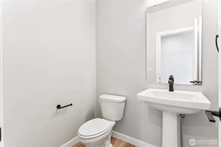 Main level half bath. Images of previously completed home.