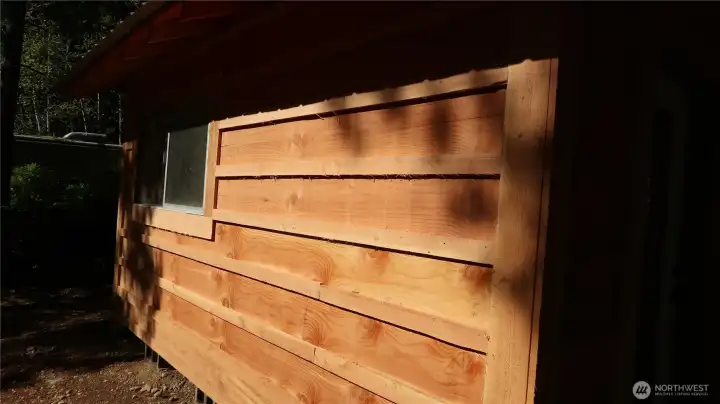 Side of shed with window to look out and see all the fish.