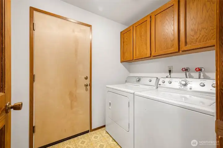 Utility room off main hallway and entrance to garage