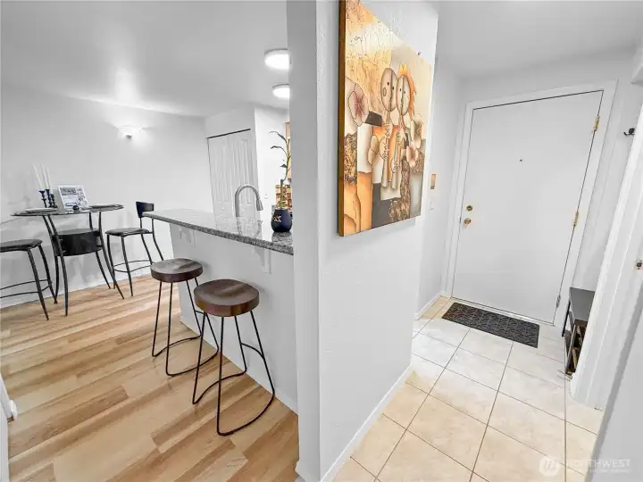 Here is a view of the kitchen, the dining room, and the eat-in bar, as seen from the bedroom doorway.