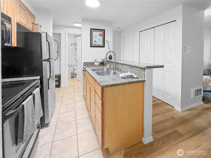 One more picture of the kitchen, this time from in front of the laundry closet.  The closet on the right side of the photo offers lots of storage space. The bedroom is just past that (with the door closed). The bathroom and entry are in the background on the left.