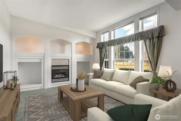 Living room with fireplace is just inside the entry with lighted nooks and architectural detail. Every room is bright with natural light.