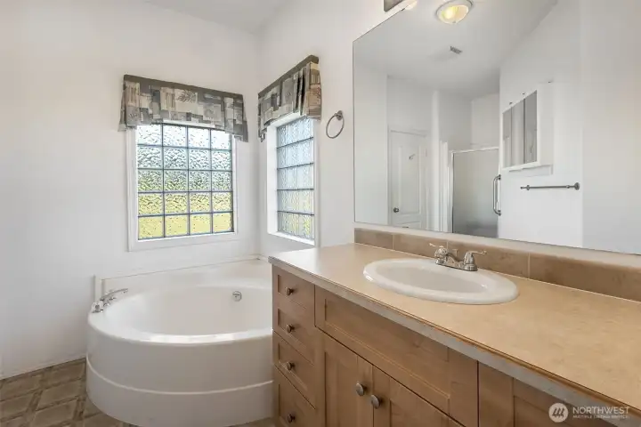 Bath in primary suite comes with a garden tub, separate shower and private toilet room
