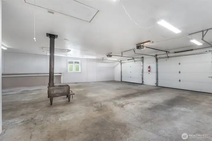 Huge garage with shop area, wood stove and tons of attic storage with 2 access, plus a half bath. Not just awesome parking and workshop but potential for ADU and business conversion!