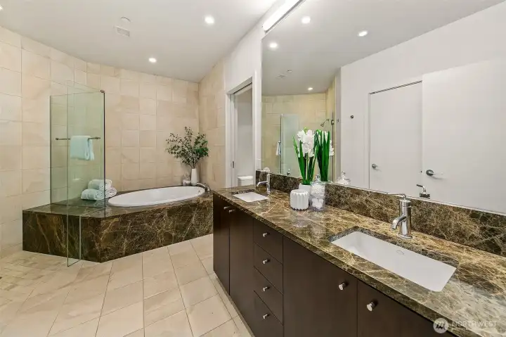 oversized soaking tub and shower double vanity and dedicated closet for more storage