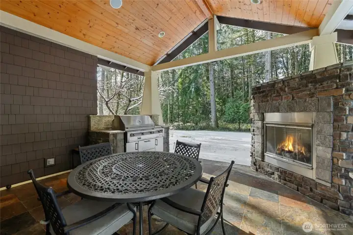 Covered patio off the kitchen with built-in grill and fireplace