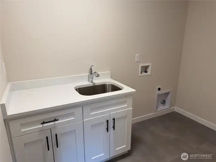 Utility sink in laundry room with counter space and cupboard Utility sink in laundry room with counter space and cupboard