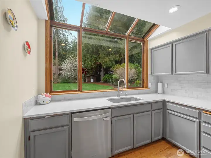 Light and airy kitchen with a view to the backyard.