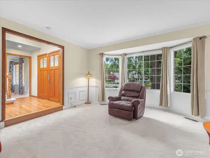 Formal living room next to front double doors and bay window.