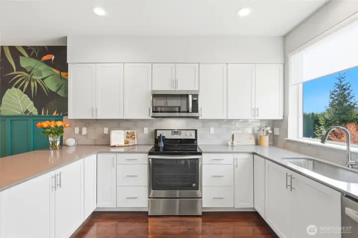 The functional kitchen features crisp white cabinetry, clean lines and efficient layout. The functional kitchen features crisp white cabinetry, clean lines and efficient layout.