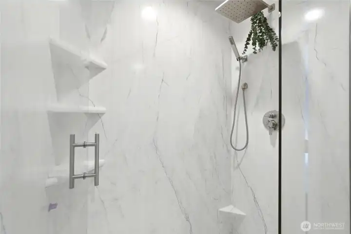 The shower has been recently remodeled with a low-maintenance, grout-free floor and surround for effortless upkeep. The shower has been recently remodeled with a low-maintenance, grout-free floor and surround for effortless upkeep.