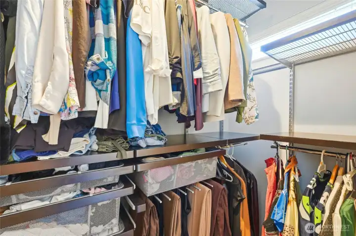 Custom Elfa closet system in the primary suite thoughtfully designed for organization and efficiency. Custom Elfa closet system in the primary suite thoughtfully designed for organization and efficiency.