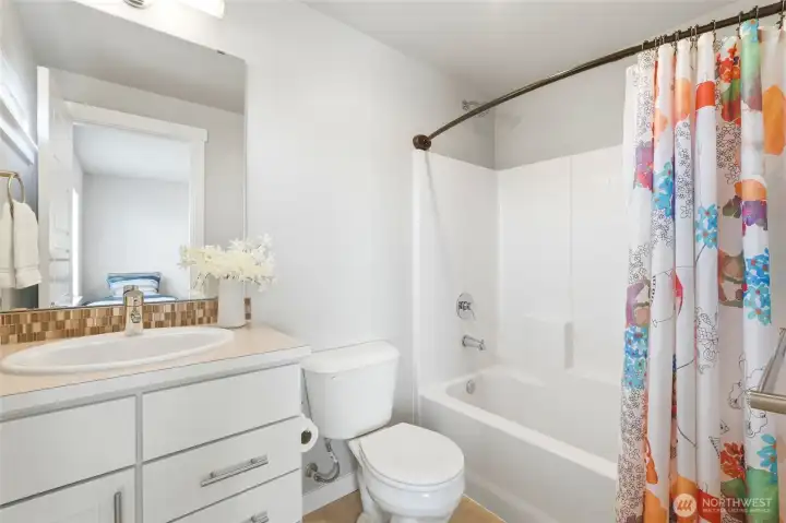The well-appointed secondary bathroom provides comfort and privacy for guests or shared living. The well-appointed secondary bathroom provides comfort and privacy for guests or shared living.