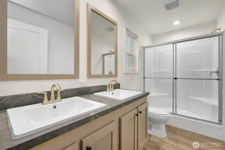 Primary bath w/ dual sinks and walk in shower.