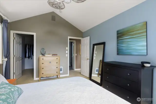 Primary bedroom looking toward the hall (door at right) and toward the walk-in closet (door at left).