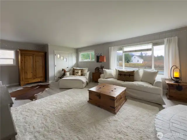 Large, bright living room with new gas heat stove