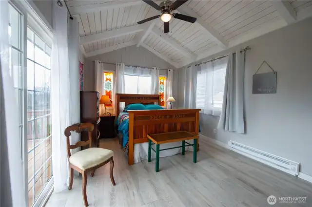 Primary suite with vaulted ceilings,, tons of natural light & slider out to nice deck that overlooks the fenced backyard.
