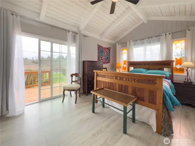 Primary suite with vaulted ceilings,, tons of natural light & slider out to nice deck that overlooks the fenced backyard.