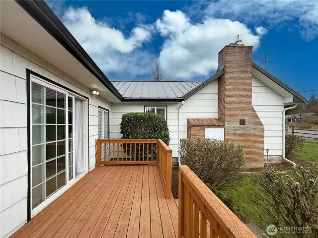 Deck of primary suite overlooking the fenced backyard & horse arena.