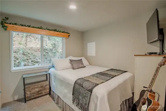 The back room is currently used as a guest bedroom but offers versatile potential for a variety of uses.
