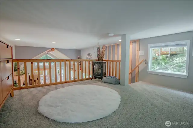 The loft features a full railing and offers fantastic views overlooking the interior of the home.
