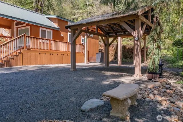 Generous covered parking enhanced by stunning rock and tree landscaping creates a perfect blend of function and beauty