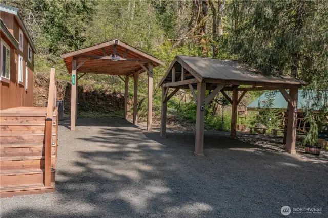 Generous covered parking enhanced by stunning rock and tree landscaping creates a perfect blend of function and beauty