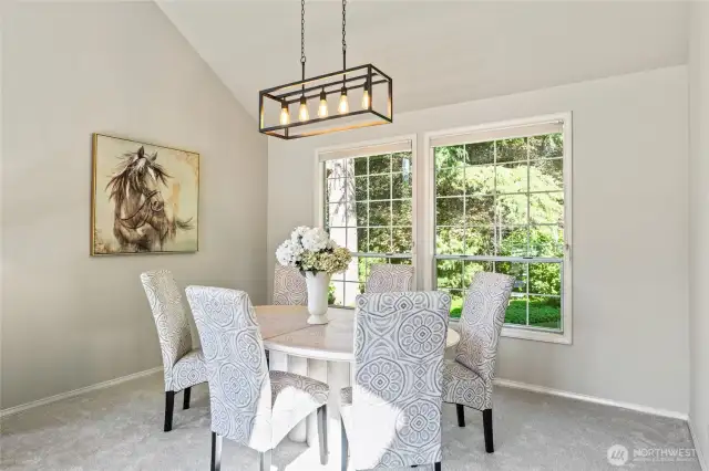Dining room with high  new light fixture views greenbelt.