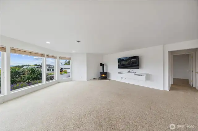Lower level family room with gas stove and large view windows make this lower level home beyond functional
