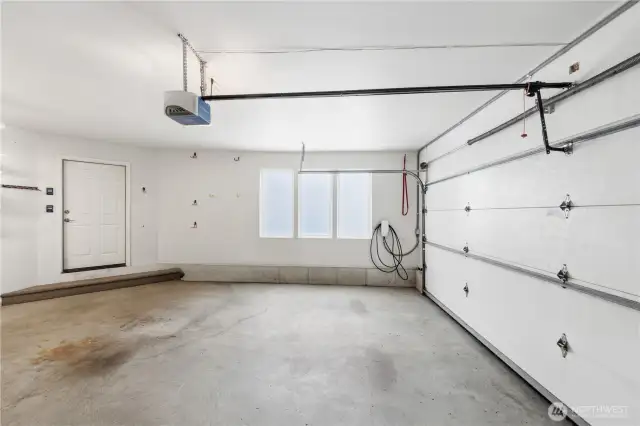 amenities, including an attached garage that accommodates parking for three vehicles and is equipped with an electric charger and a convenient bathroom—perfect for modern living.