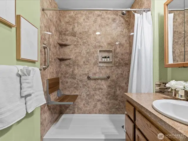 Newer custom assessable walk-in shower with grab bars and seat