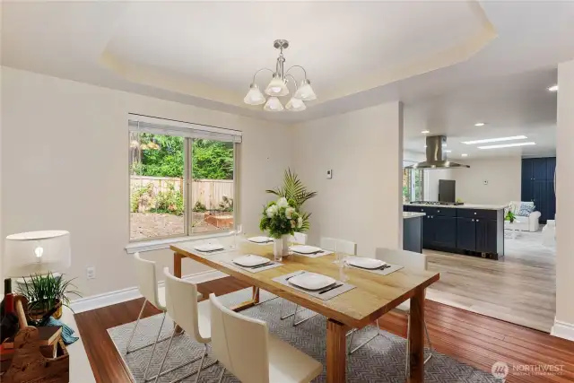 Formal dining room with coffered ceilings virtually staged