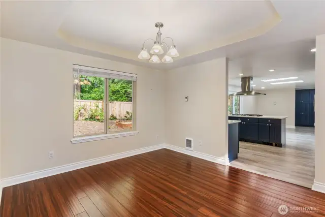 Formal dining room with coffered ceiling unstaged