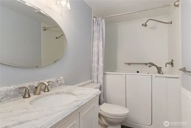 Guest bathroom with walk-in jetted tub with shower